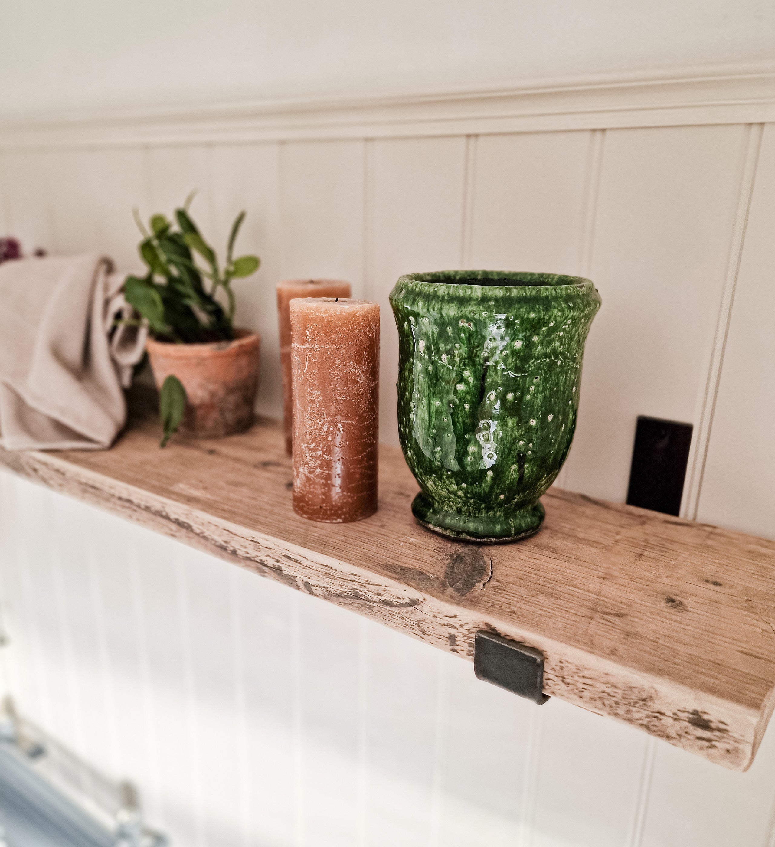 Reclaimed wood shelves with aged steel brackets