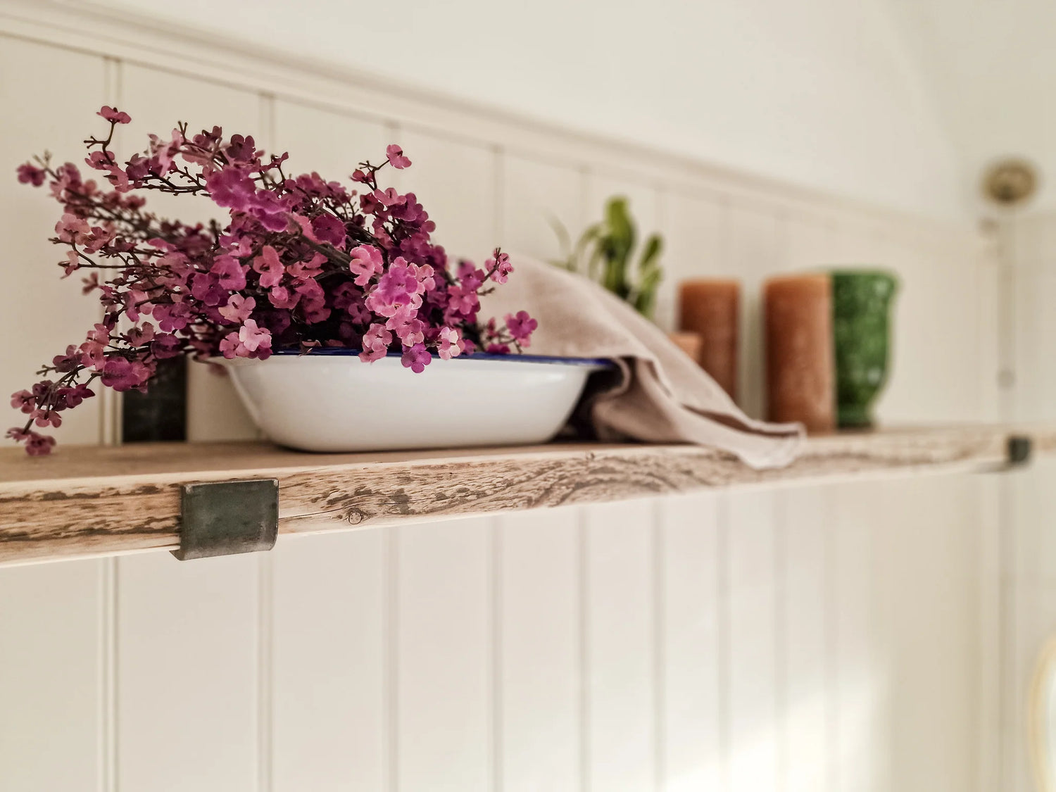 Reclaimed wood shelves with aged steel brackets